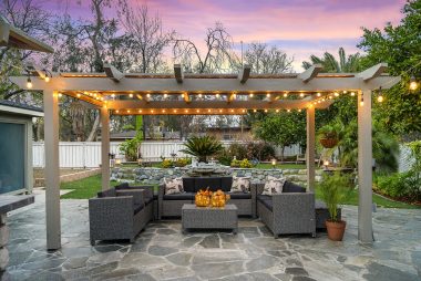 Talk about an entertainer's dream -- this backyard has so much to offer: lighted pergola, included patio furniture, water feature, low-maintenance artificial turf, gardening area, and a built-in BBQ with refrigerator and sink!