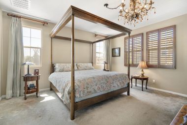 Master bedroom suite with custom wood window shutters.
