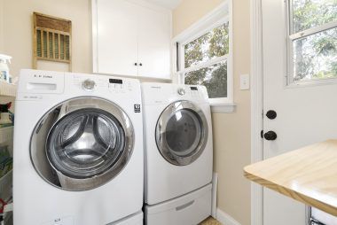 Separate indoor laundry room off the kitchen, and washer/dryer convey with sale.