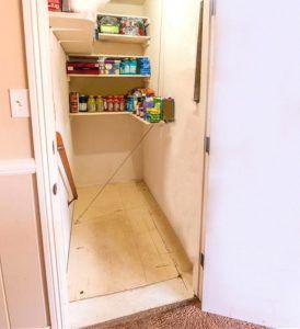 Pantry with pull-up trap door which leads to the garage and basement (see next photo with pull-up door in open position).
