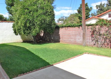 Low maintenance backyard with 60+-yr-old orange tree! Automatic sprinklers and 2-car garage also!