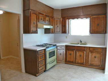 Spacious kitchen with brand new linoleum flooring. Door to left leads to office, half bath, and separate laundry room!