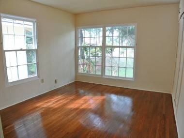Front bedroom with lots of natural light, recently refurbished hardwood floors and ample closet space.