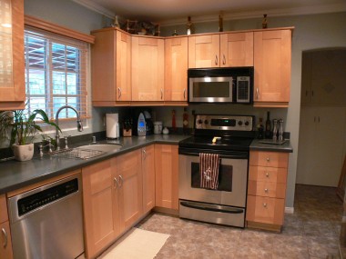 Remodeled kitchen with granite counter tops and stainless steel appliances.