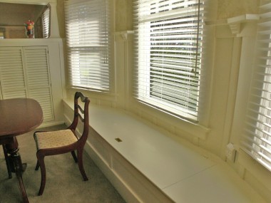 Original built-in window seat in the formal dining room. Perfect for storing your table leaf, linens, decorations, etc.