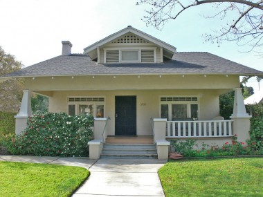 Classic California Bungalow with porch covered by overhanging roof and supported by substantial columns