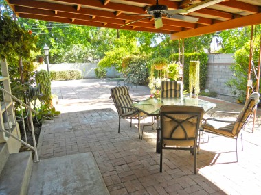 Lovely, breezy covered patio off the side of the house, which makes room in the backyard for a pool.