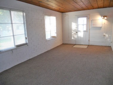 Guest room,. studio, or playroom. Note the charming wood ceiling and ample windows which let in lots of light.