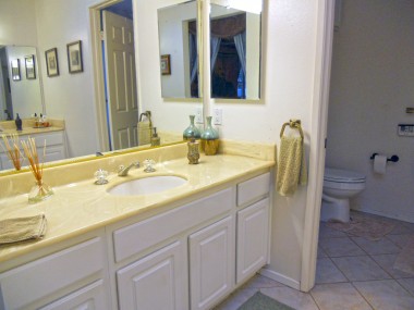 Private master bathroom with two vanities, and a separate room with a soaking tub.
