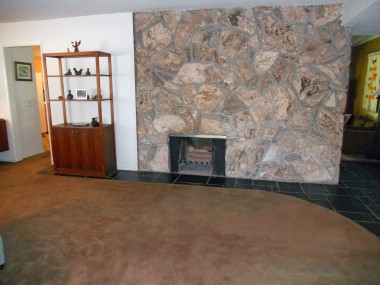 View of fireplace in formal living room.