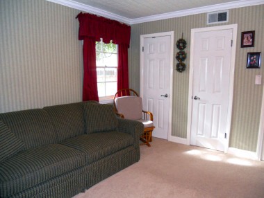 Alternate view of secondary bedroom with two closets, new doors and crown molding.