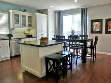 Remodeled kitchen with island and eating area overlooking the expansive backyard.