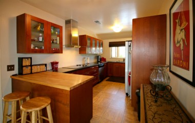 Remodeled kitchen with newer cabinets, double oven, dishwasher, and breakfast bar.