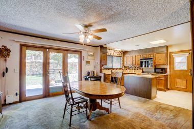 Large formal dining room and kitchen combo with newer French doors to backyard.
