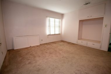 Front bedroom with hardwood floors under carpeting, and large closet (doors can easily be reinstalled).