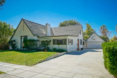 Tudor style with large front picture window and long driveway with detached 2-car garage with 2nd story storage.