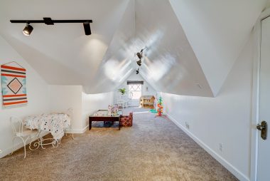 Upstairs loft with plenty of room for gym, play area, or office, with a huge attic area for storage!