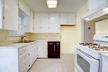 Charming kitchen with lots of cabinetry, dishwasher, gas stove, and tile flooring.