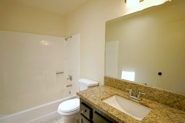 Remodeled hallway bathroom for the 3 bedrooms on one side of the house. Granite counter top on new vanity.