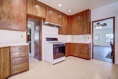 Alternate view of kitchen with view into living room.