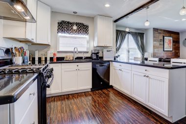 Remodeled kitchen with Silestone counter tops, dishwasher, 6-burner gas stove with optional griddle, and pendant lighting over the breakfast bar.