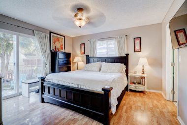 Master bedroom suite with ceiling fan, slider overlooking the huge backyard, two closets (one of which is a walk-in), as well as a private bathroom.