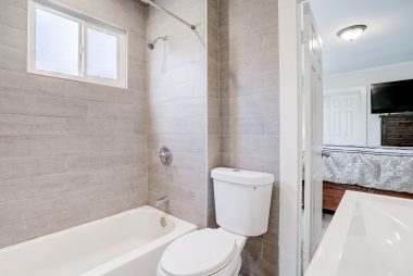Remodeled bathroom with shower in tub.