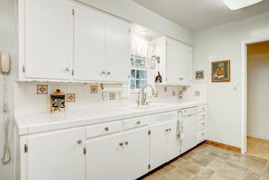 Updated bright kitchen with tile counters.