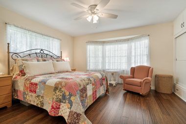 Large bedroom overlooking the back yard with bamboo flooring, ceiling fan, and two closets (one is a cedar-lined walk-in).