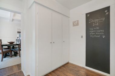 Alternate view of kitchen with large pantry and a fun chalk board for menus or shopping lists.