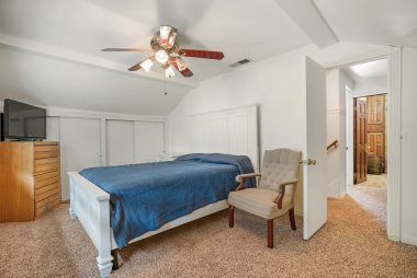 Second upstairs spacious bedroom with ample closet space, ceiling fan, and brand new carpet.
