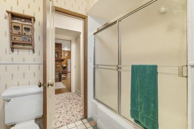 Alternate view of hallway bathroom with shower in tub.
