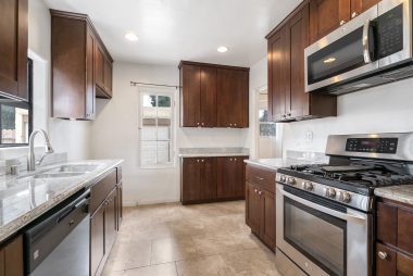 Remodeled kitchen with stainless steel appliances (except refrigerator), including built-in microwave, recessed lighting, and garden window.