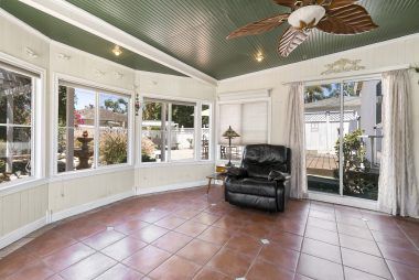 Alternate view of step-down family room overlooking the serene low-maintenance backyard.