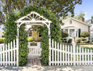 Charming entry gate into the front yard with address placard.