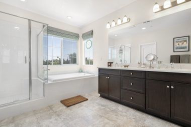 Master bathroom with dual sinks, separate shower and tub, as well as an enormous walk-in closet.
