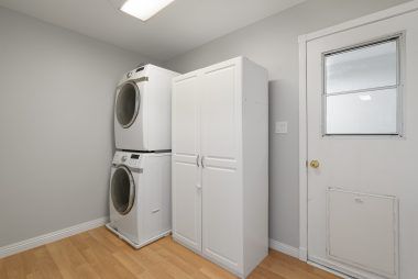 Separate indoor laundry room with space for cabinetry, shelving, and even side-by-side units.