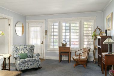 Front entrance with plantation shutters and double pane windows.