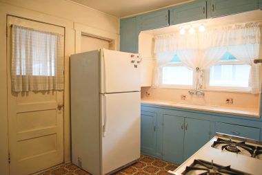 Kitchen with gas stove and doorway leading to laundry room.