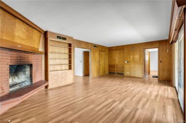 Alternate view of the family room with brand new laminate flooring. The original flooring in this room was cork, while the majority of the home boasts the original hardwood floors.