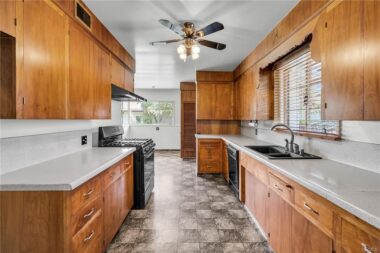 Spacious kitchen with original real wood cabinetry and lots of preparation countertops.
