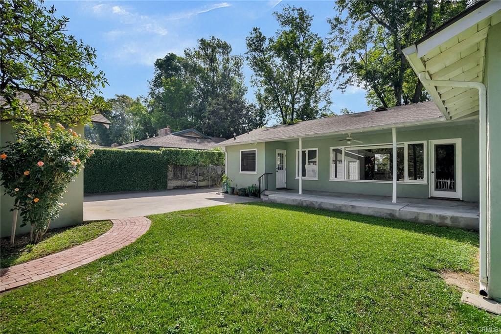 Another view of backyard toward the driveway and 2-car detached garage.