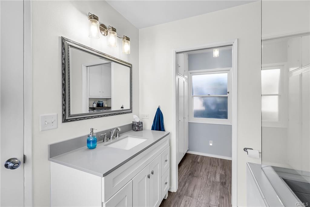 Remodeled primary bathroom with view into the laundry room.