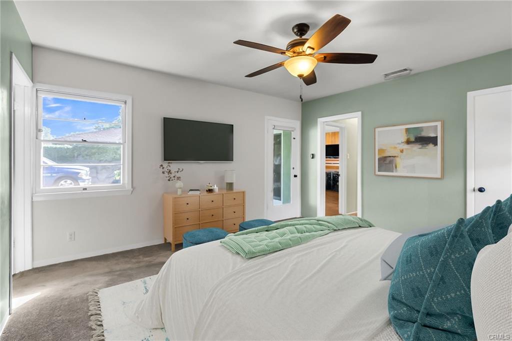 Alternate view of primary suite with view to separate entry door to backyard. Virtually Staged.