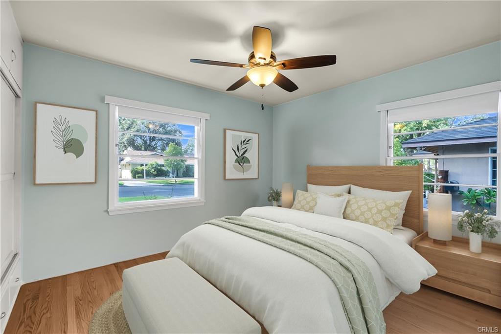 Front bedroom with ceiling fan and original hardwood flooring. Virtually Staged.