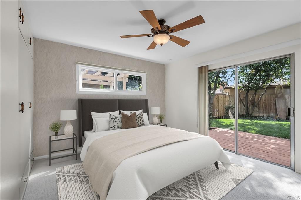 Bedroom #3 with slider to the backyard deck to enjoy morning coffee or fresh squeezed juice from your very own fruit trees, while enjoying the birdsong and sun. (Virtually Staged)
