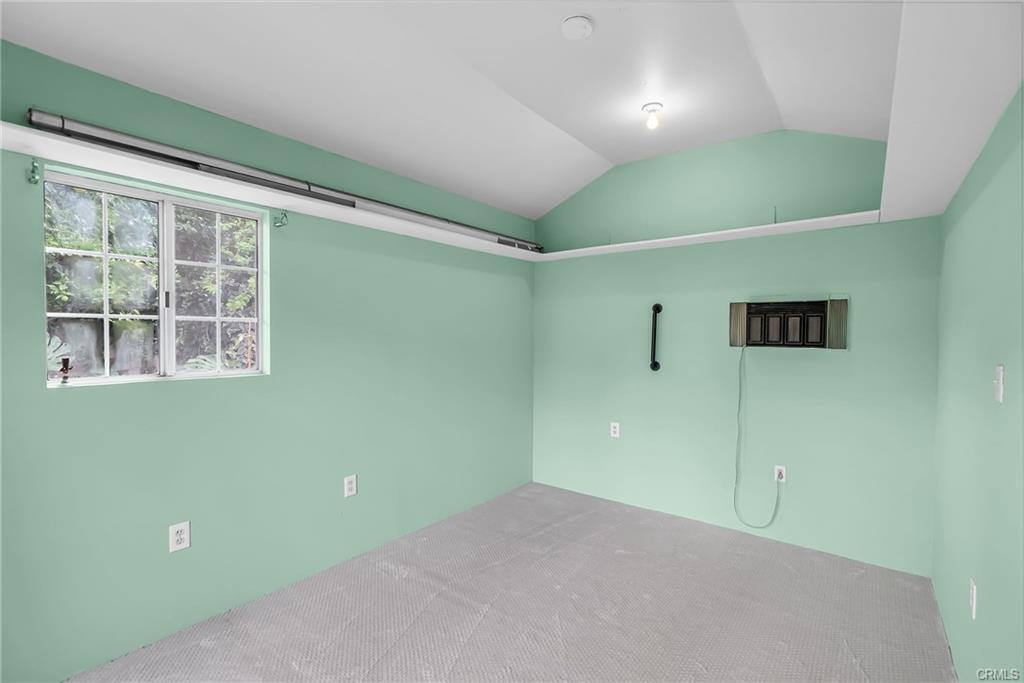 Alterate view of the "craft house" with electrical outlets, an A/C unit, and brand new carpet.