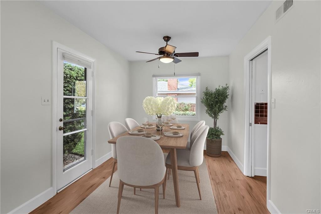 Formal dining room off the kitchen, with a French door leading to the private and lushly landscaped backyard. Brand new ceiling fan. (Virtually Staged)