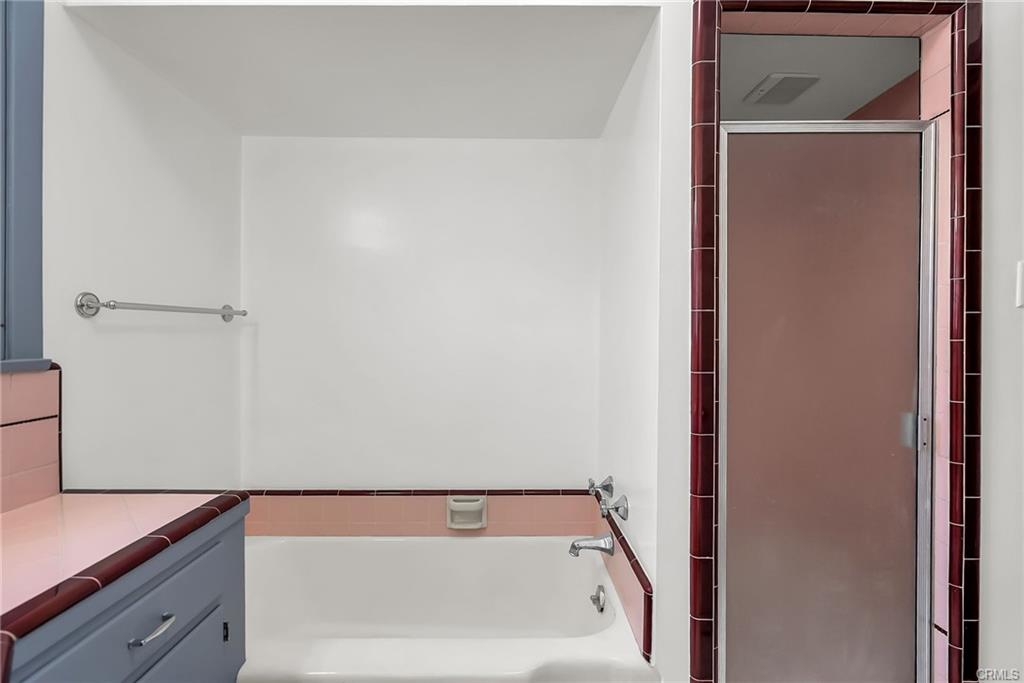 Alternate view of vintage hallway bathroom with tub and separate shower.