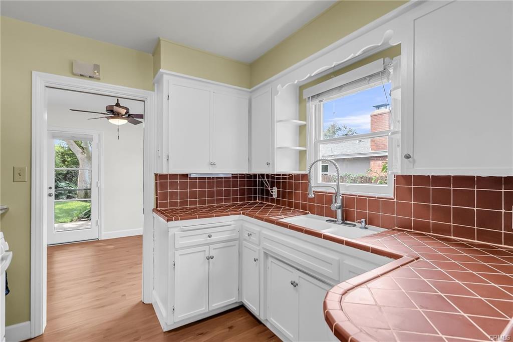 Vintage kitchen is just darling! Check out the cute shelves over the sink -- and don't miss the extra shelving to the left of the refrigerator which would be ideal for recipe books!